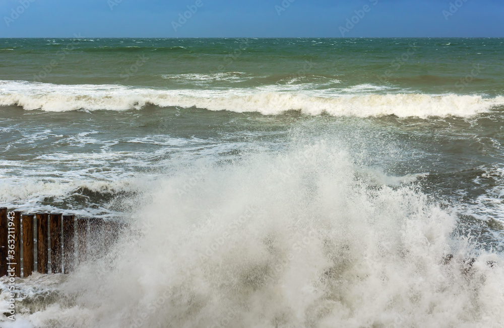 Breakwaters in the sea. Waves beat against breakwaters. Splashing sea waves. Storm waves in the Baltic sea. Breakwaters in the sea. Waves beat against breakwaters. Splashing sea waves. Storm waves in the Baltic sea.