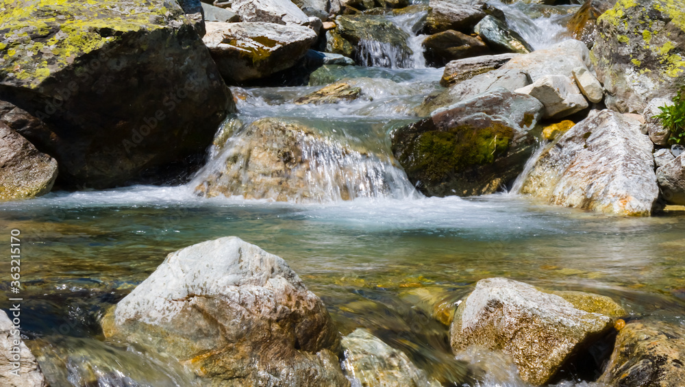closeup rushing mountain river with small waterfall closeup rushing mountain river with small waterfall
