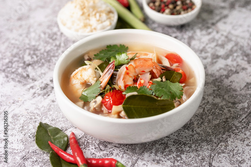 Food and drink, traditional Thai cuisine. Spicy tom yam kung, tom yum sour soup with shrimp, prawn, coconut milk, lemongrass and chili pepper in a bowl