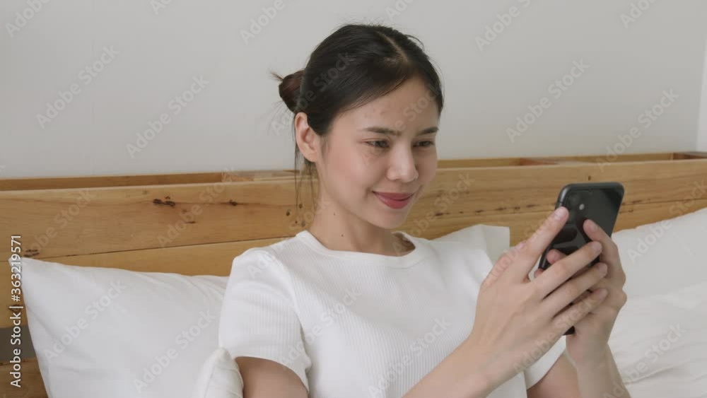 Asian woman holding a smartphone and using online social on lifestyle. Technology for communication concept. Asian woman holding a smartphone and using online social on lifestyle. Technology for communication concept.