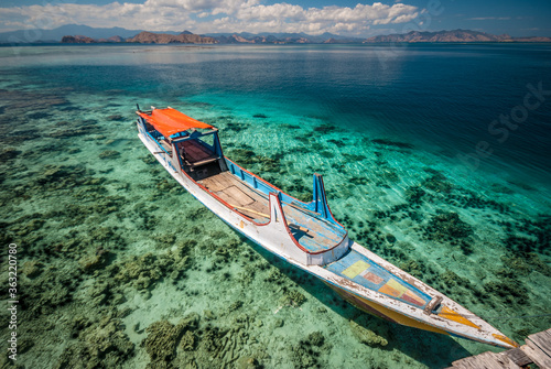 Boat at the deck in the island of Kanawa, Flores © luisapuccini