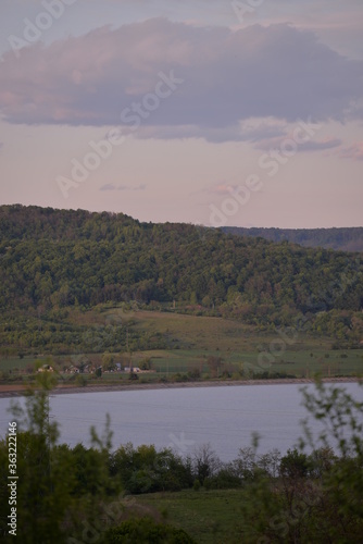 Fototapeta Naklejka Na Ścianę i Meble -  landscape with forest and lake. houses located near a field ready for cultivation