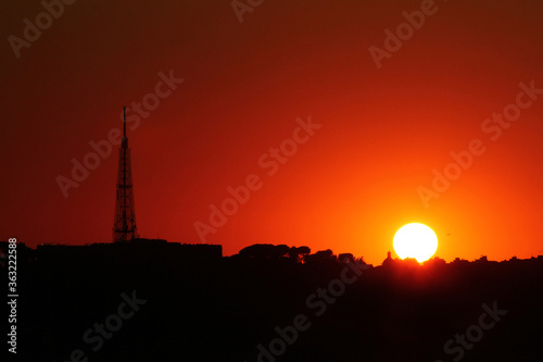 Silhouette of Telecommunication mast television antennas on sunset © Maria Letizia Avato