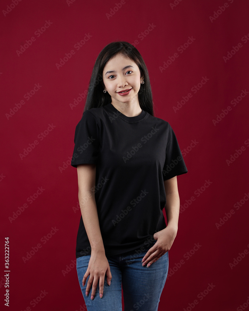 Front view white t-shirt Closeup on female body, woman girl in empty black t-shirt isolated on red background. Design woman t-shirt template and mockup for print. Front view white t-shirt Closeup on female body, woman girl in empty black t-shirt isolated on red background. Design woman t-shirt template and mockup for print.