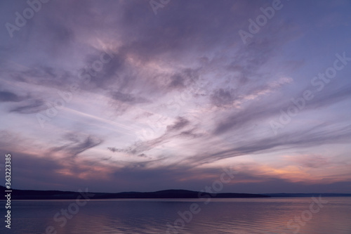 beautiful clouds during sunset over the lake © Анна Майорова