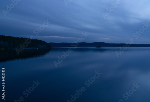 beautiful clouds during blue hour over the lake © Анна Майорова
