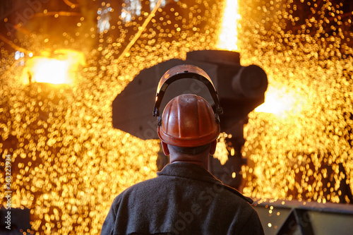 Steelmaker at ingot casting. Electric arc furnace shop EAF. Metallurgy.