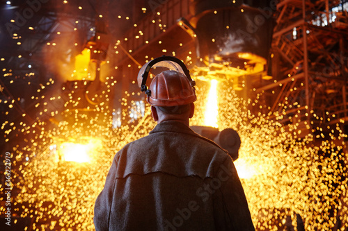 Steelmaker at ingot casting. Electric arc furnace shop EAF. Metallurgy.