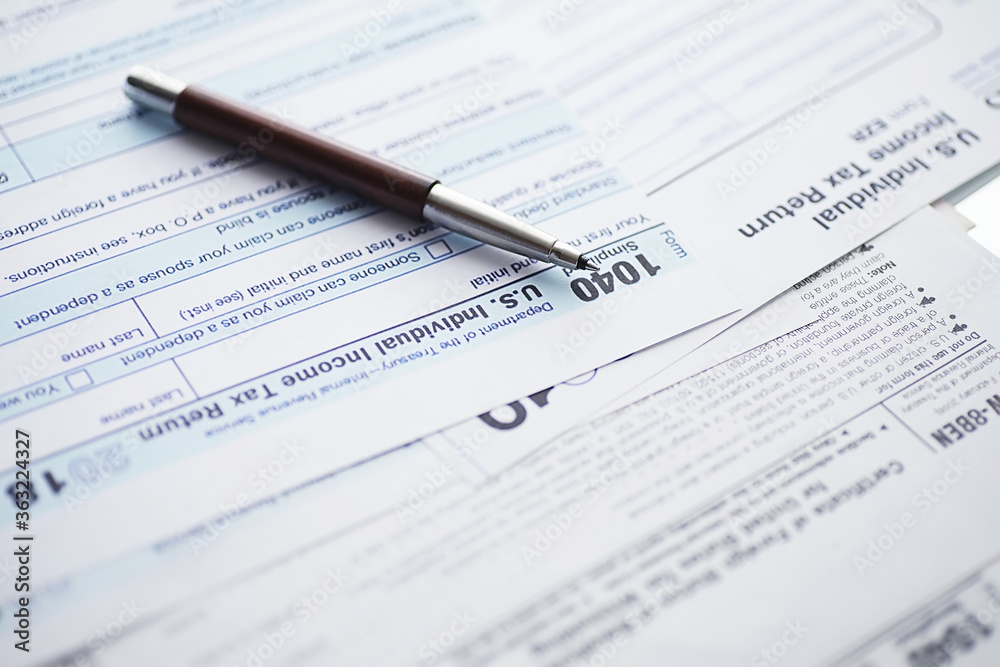 Annual tax reporting. Tax form on the table. Financial statements for signature.