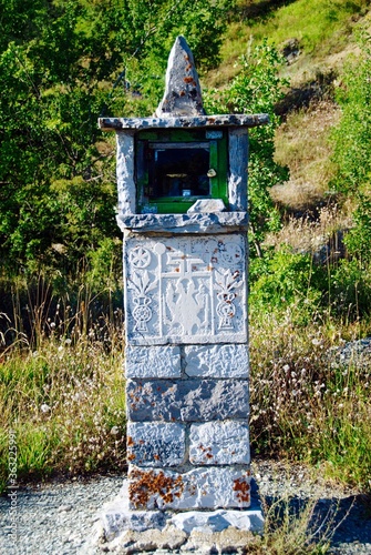 A traditional stone-made candle-holder, faldstool, iconostasis at Vradeto village, Zagoria area, one of the 45 villages known as Zagoria or Zagorochoria in Epirus region of southwestern Greece. photo