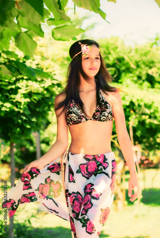 girl with long hair in a swimsuit walking on the tropics girl with long hair in a swimsuit walking on the tropics