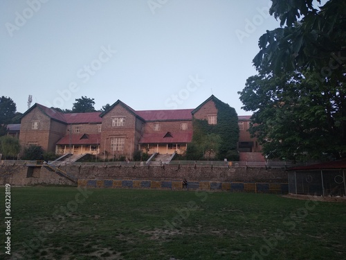 School building  With green trees
