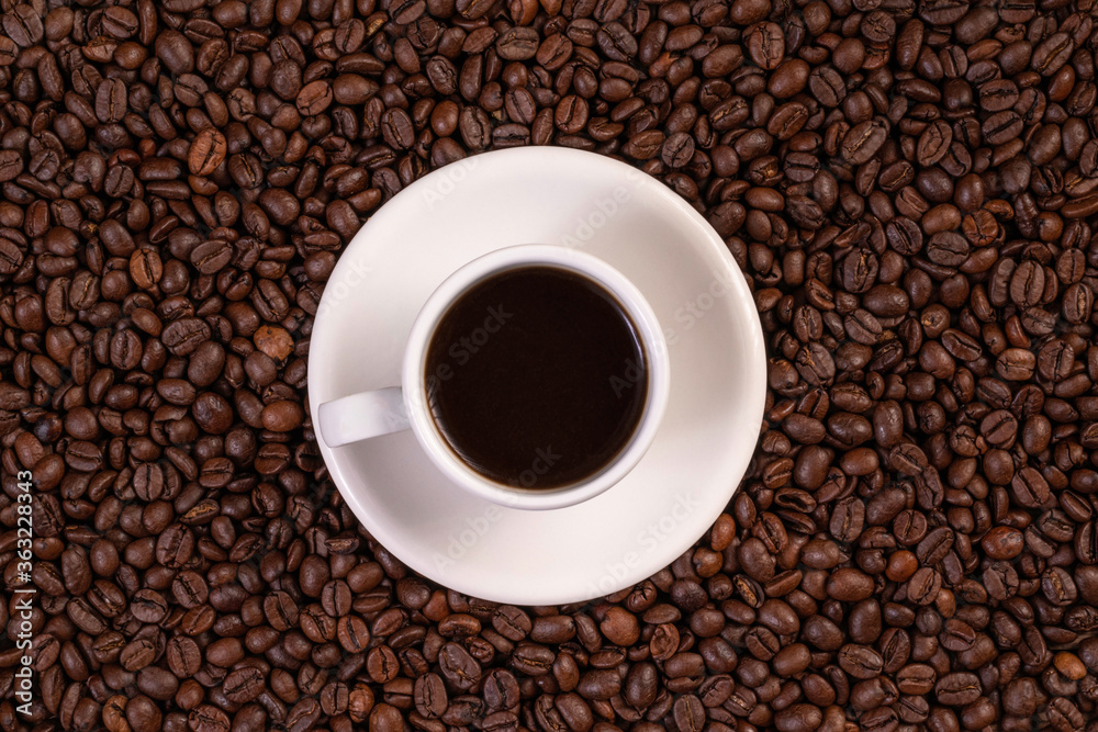 Cup of coffee on coffee beans background Cup of coffee on coffee beans background