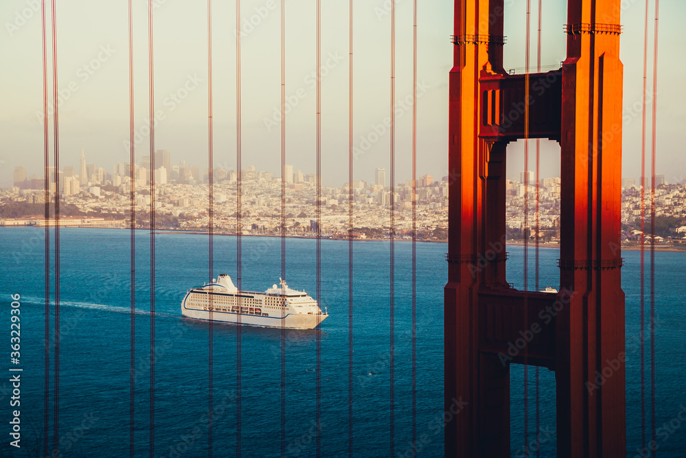Golden Gate Bridge with cruise ship at sunset, San Francisco, California, USA