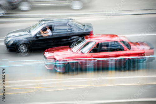 Cars at speed. Street racing. Cars in motion. Blurry cars at speed. Speed.