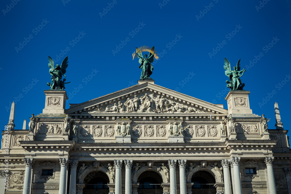 Fototapeta premium different big sculptures adorn front of national opera and ballet theatre in Lviv