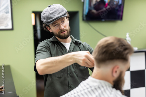 Haircut men Barbershop. Men's Hairdressers barbers. Barber cuts the client machine for haircuts.