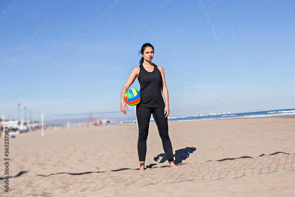 Beach volleyball, summer vacation, sport and people concept - young woman with ball playing volleyball on beach. Beach volleyball, summer vacation, sport and people concept - young woman with ball playing volleyball on beach.
