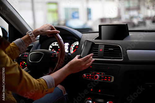 Template for Mobile phone magnet car mount phone holder, for GPS. Lifestyles photo in car. Interior, front view. With woman hand holding phone. Different angels.