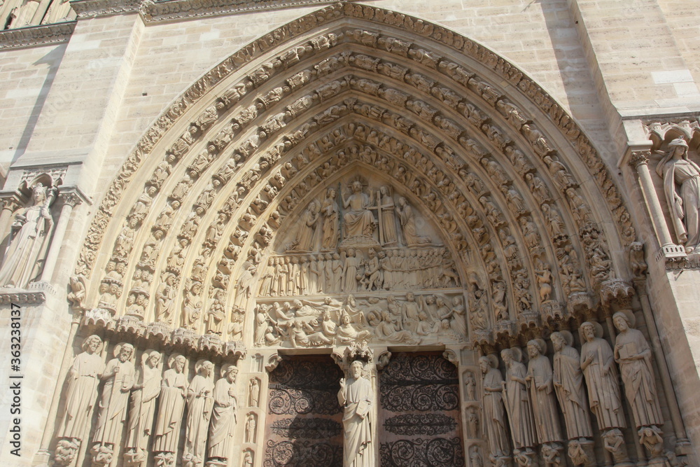 A close up of the exterior facade of the Notre Dame of Paris, France
