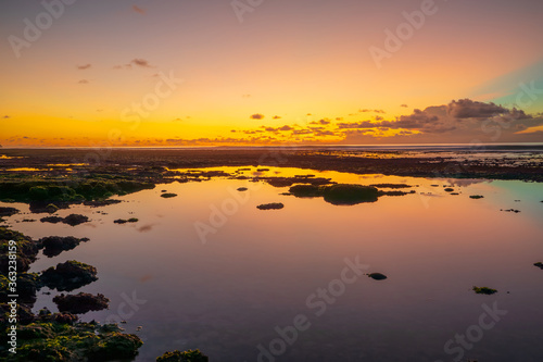 Magnificent seascape. Beach at sunset during low tide. Sunset golden hour. Sunlight reflection in water. Bingin beach  Bali  Indonesia