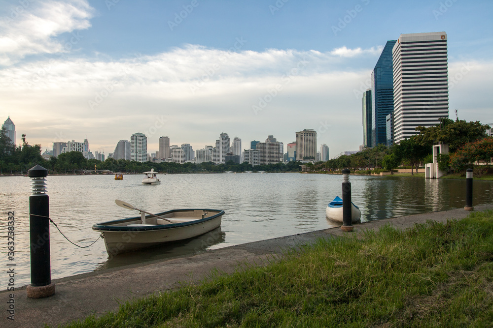 Fototapeta premium Bangkok Skyscraper with boat in the garden, Thailand