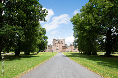 Blue sky over the driveway and trees on a summers day at Glamis Castle, Scotland. photo