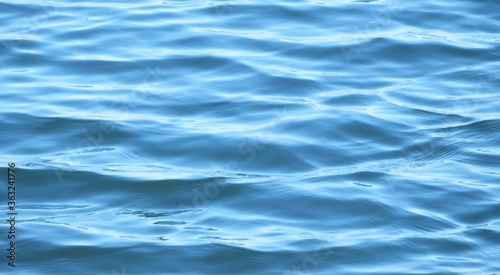 Beautiful bright blue water surface with soft waves on Florida lake, natural background 