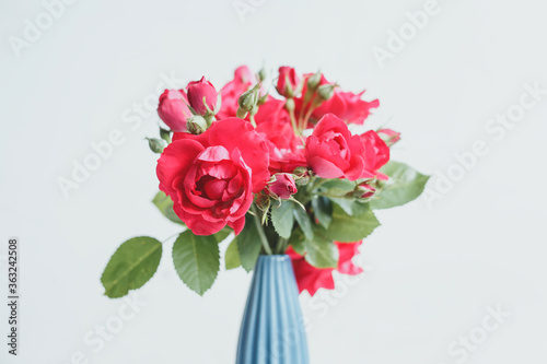 Bouquet of red roses in a blue vase © Kristina