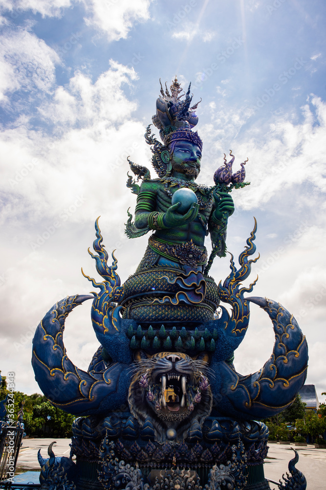 Wat Rong Suea Ten or The Blue Temple translates as House of the dancing tiger. A monumental, modern Buddhist temple distinguished by its vivid blue coloring & elaborate carvings in Chiang Rai Province Wat Rong Suea Ten or The Blue Temple translates as House of the dancing tiger. A monumental, modern Buddhist temple distinguished by its vivid blue coloring & elaborate carvings in Chiang Rai Province