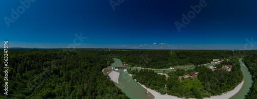 Aerial view over the bavarian Isar river and a weir next to green trees of a big forest. photo