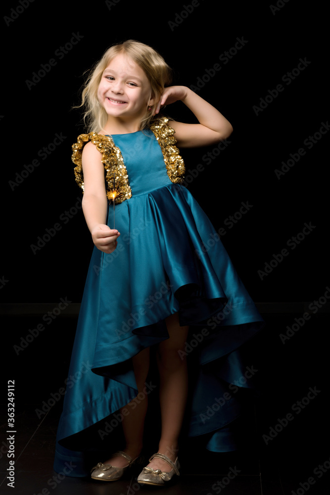 Charming Girl in Nice Blue Dre Holding Burning Sparkler Charming Girl in Nice Blue Dre Holding Burning Sparkler