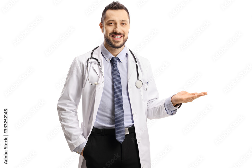 Young male doctor smiling and holding his hand to the side Young male doctor smiling and holding his hand to the side