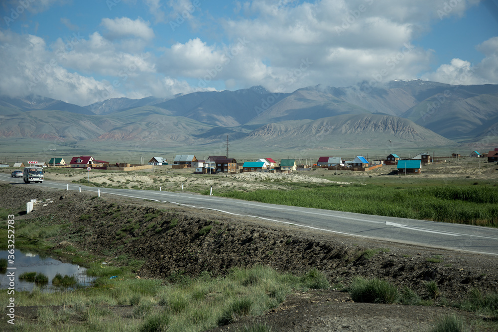 Traveling in the Altai Republic. The plot of the Chuysky tract. The city of Kosh-Agach. Local Russian village with a national lifestyle Traveling in the Altai Republic. The plot of the Chuysky tract. The city of Kosh-Agach. Local Russian village with a national lifestyle