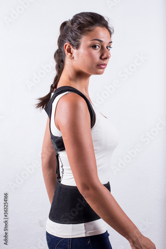 Instruction how to wear posture corrector. Different angels. Women wearing back support belt for support and improve posture consists of two parts for the back and lower back. Details, quality