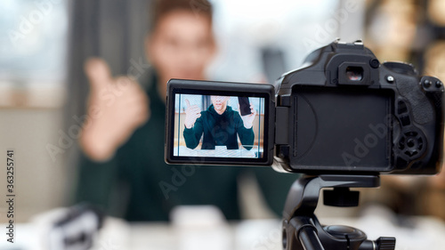 Close up of camera screen. Male technology blogger recording video blog or vlog review of new smartphone at home studio. Blogging  Work from Home concept