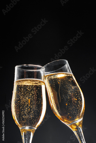 Glass full of champagne on black background