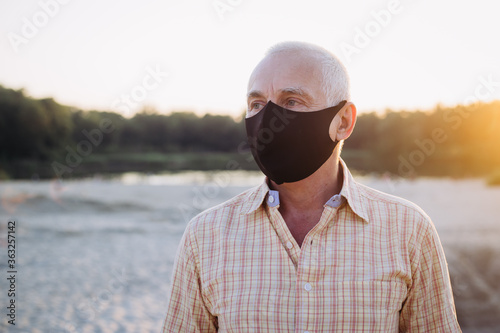 Senior man wearing protective mask, coronavirus, illness, infection, quarantine, medical mask © Marharyta
