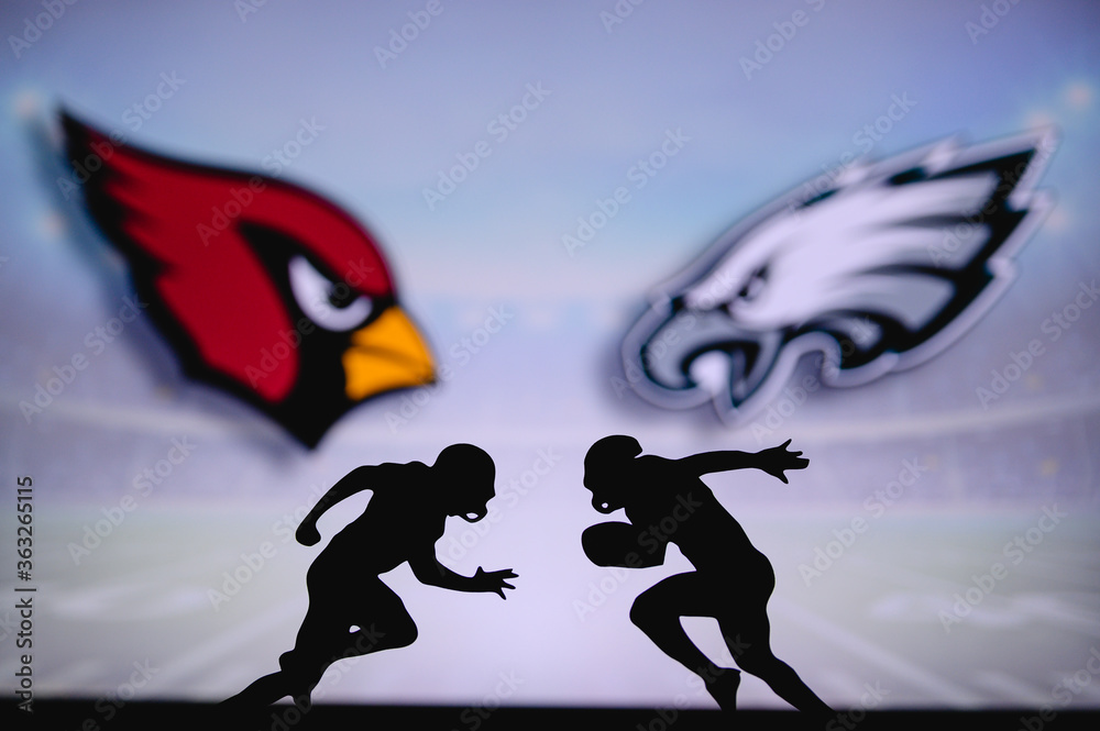 Arizona Cardinals vs. Philadelphia Eagles. NFL match poster. Two american  football players silhouette facing each other on the field. Clubs logo in  background. Rivalry concept photo. Stock Photo