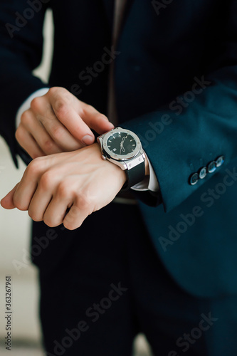 The groom is going to the wedding to the bride in a suit watch