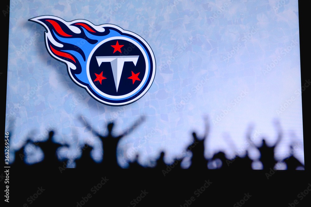 Tennessee Titans. Fans support professional team of American National  Foorball League. Silhouette of supporters in foreground. Logo on the big  screen. Stock Photo