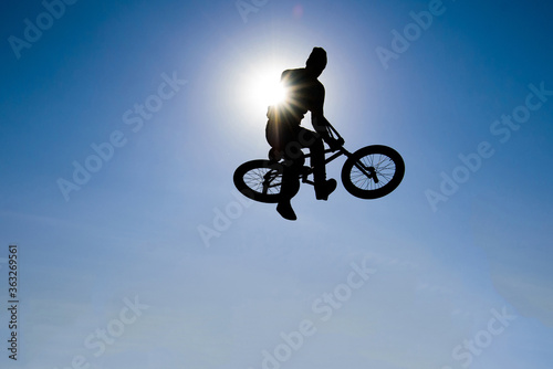 Silhouette  of bicyclist against the background of the sky. © pavlik011