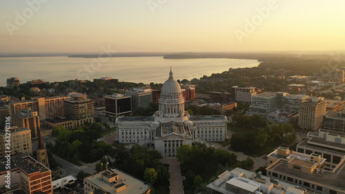 Aerial view of City of Madison. The capital city of Wisconsin from above. Drone flying over Wisconsin State Capitol in downtown. Sunny morning, sunrise (sunset), sunlight, summertime photo