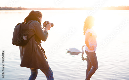 photographer photographs a model girl at sunset