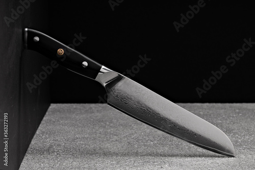 Tableau sur toile A large kitchen knife with a black handle on a dark background