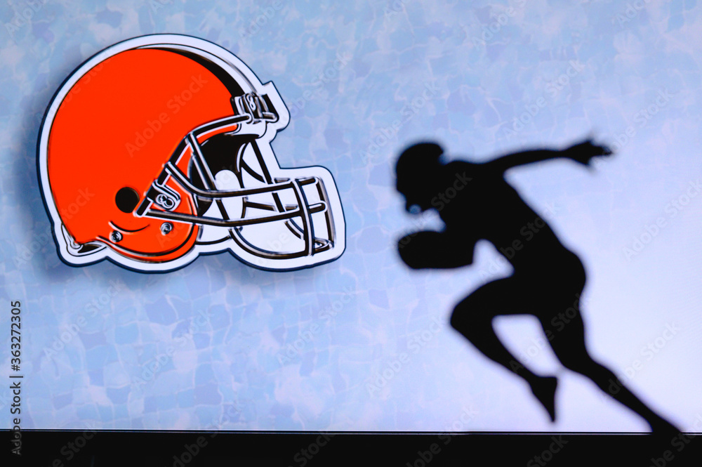 Cleveland Browns. Silhouette of professional american football player. Logo  of NFL club in background, edit space. Stock Photo
