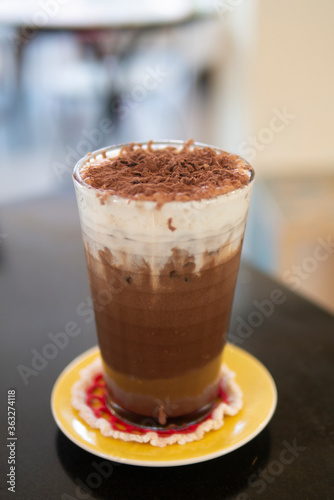 iced cocoa chocolate drink with cream foam topped with cocao powder cold drink beverage at cafe for refresh