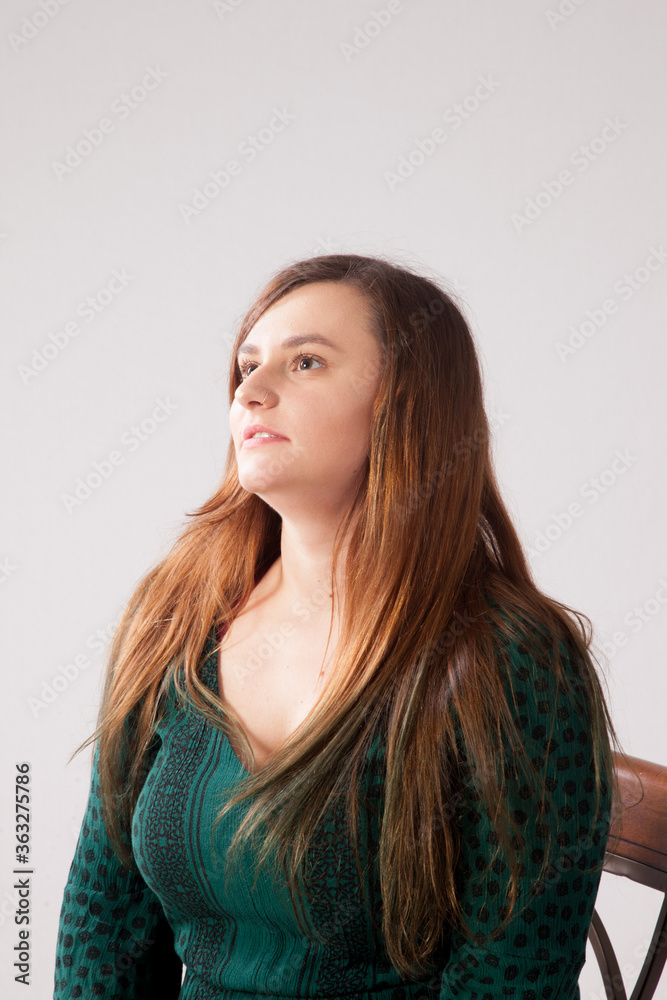 Fototapeta premium Pensive woman in a green dress