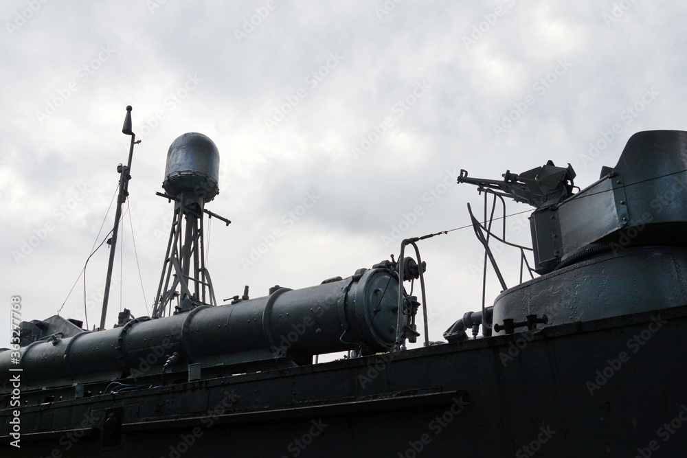 fragment of an old submarine against a cloudy sky. fragment of an old submarine against a cloudy sky.