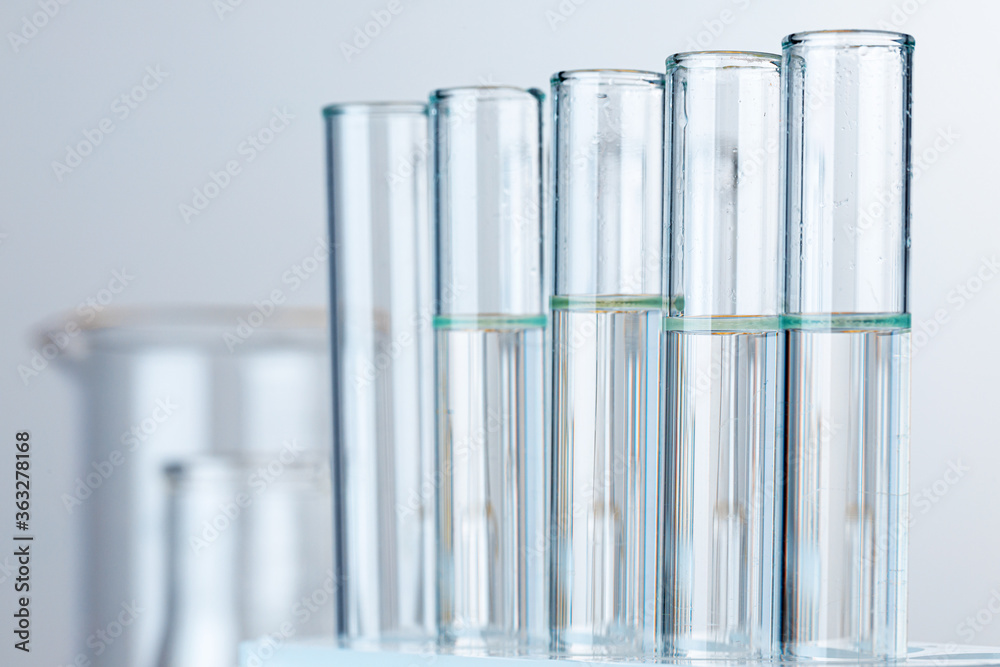 Laboratory glass test tubes with transparent liquid close up Laboratory glass test tubes with transparent liquid close up